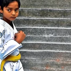 Artistic representation for Seven - year - old Rourkela taekwondo kid vows to bring gold medal home.